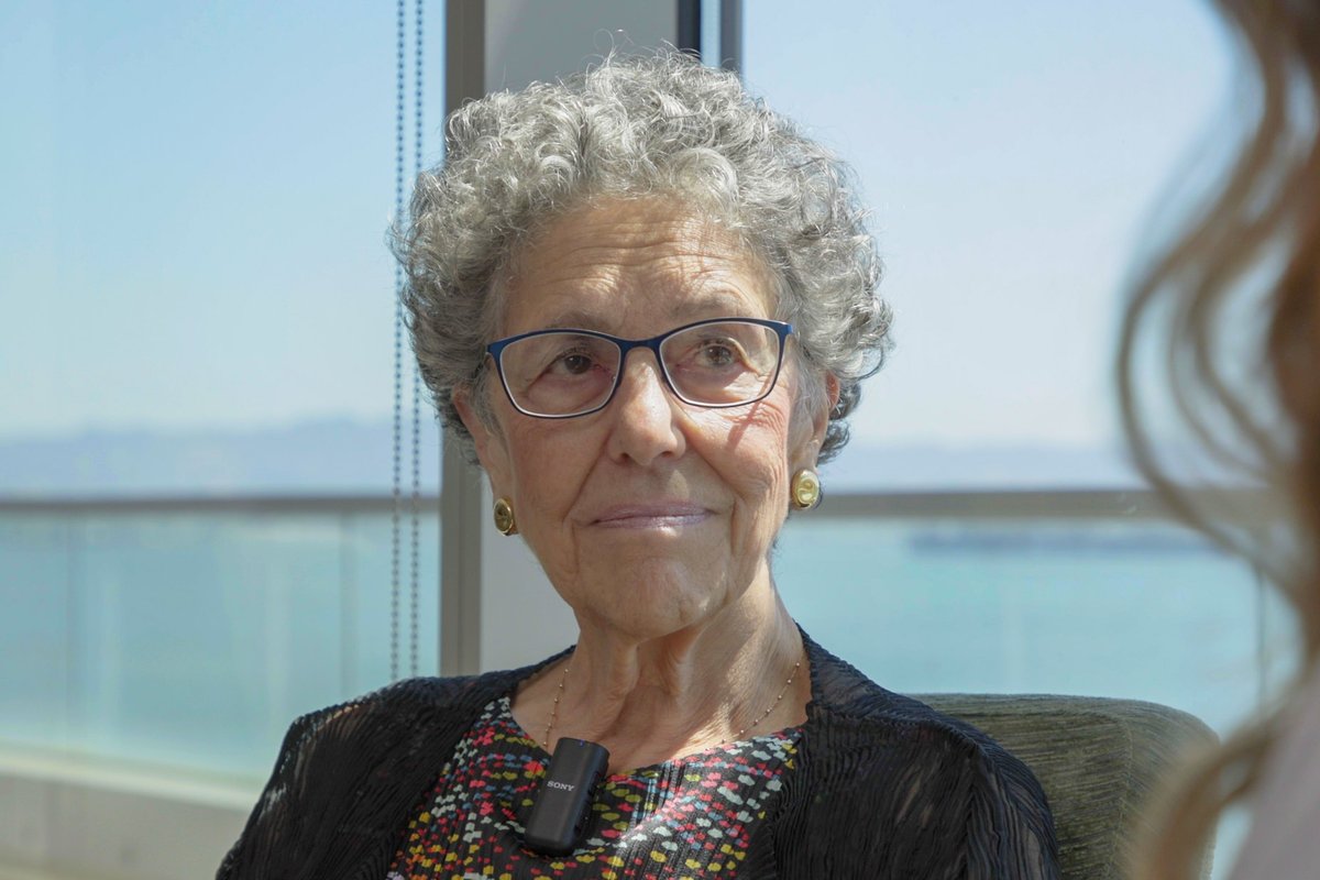 Dr. Linda Giudice seated for an interview by a window overlooking the bay.
