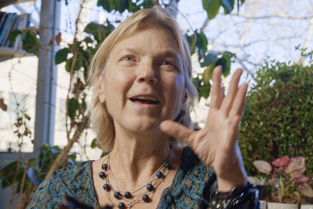 Dr. Linda Griffith speaking animatedly, gesturing with one hand.